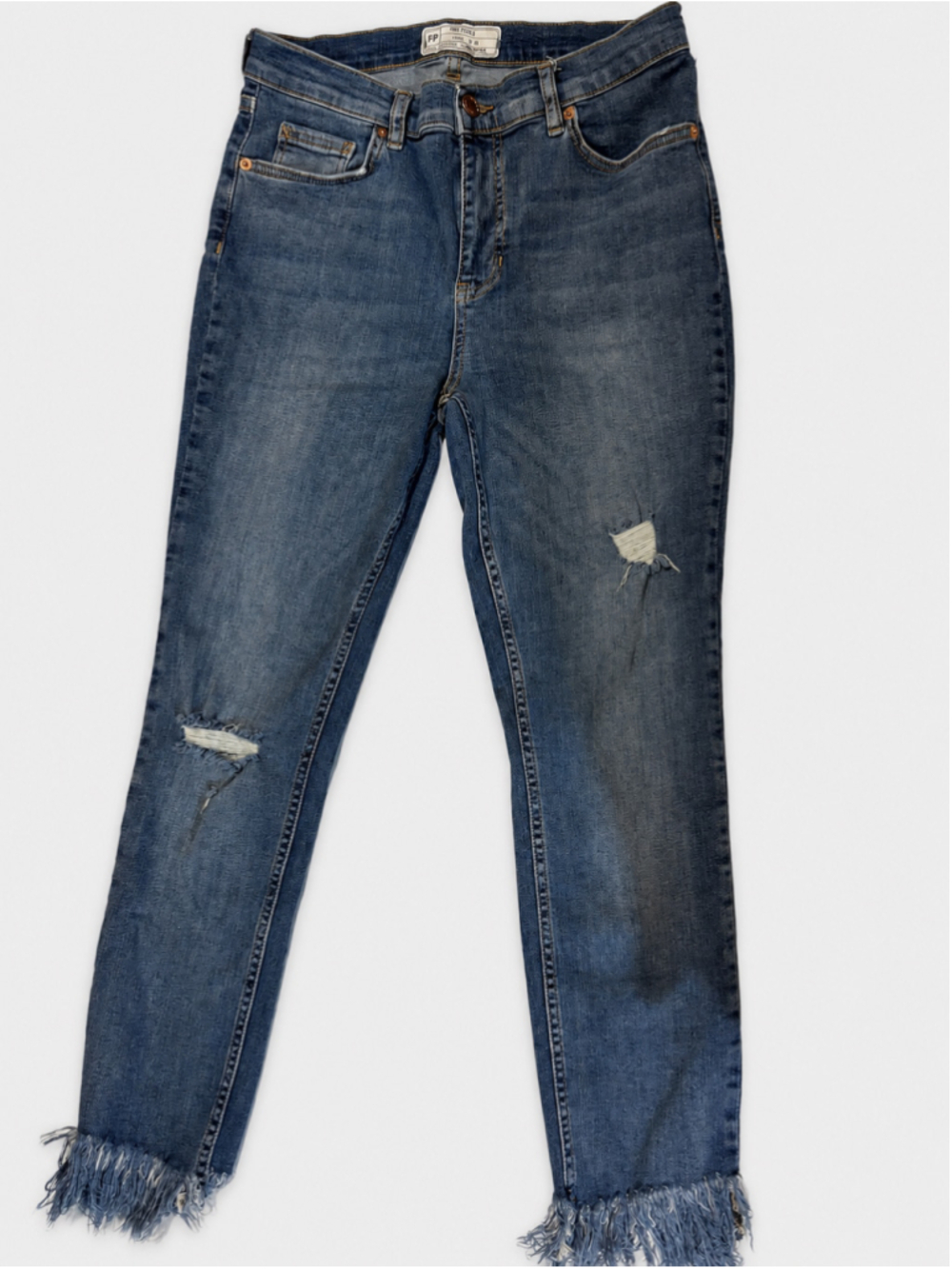 Free People women’s distressed skinny jeans in a medium blue wash, tagged size W